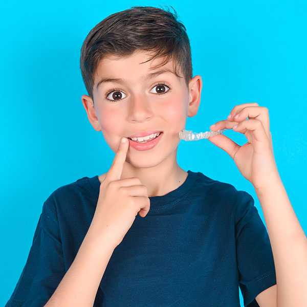 Child holding orthodontic appliances